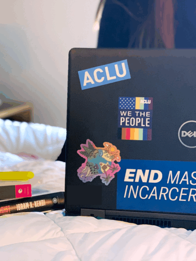 Person working on laptop with ACLU stickers