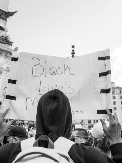Protester holding black lives matter sign on monument circle
