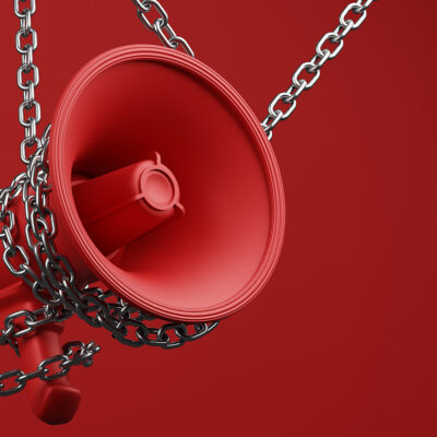 Chained bullhorn on red background
