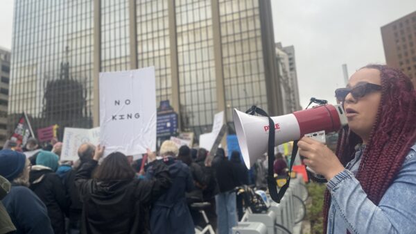 DeOnyae-Dior Valentina speaks into a megaphone at a protest.