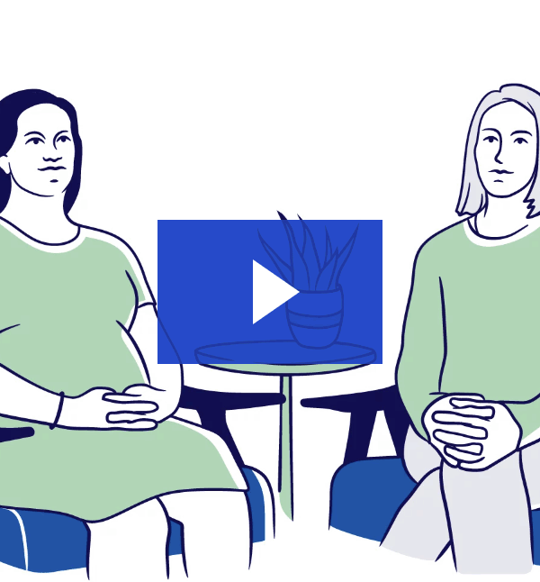 Two people sitting on chairs with a table between them