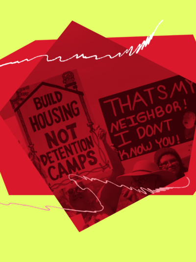 People carry signs at a demonstration.