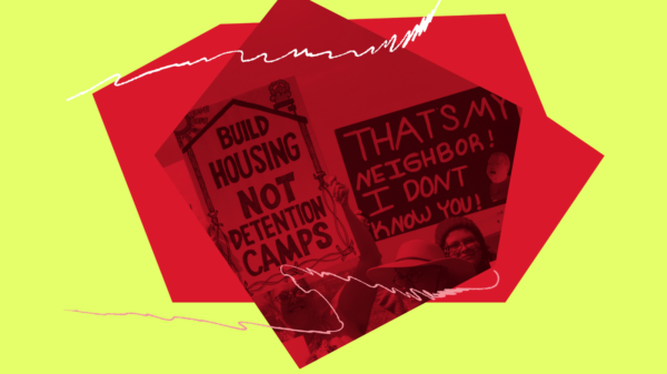 People carry signs at a demonstration.
