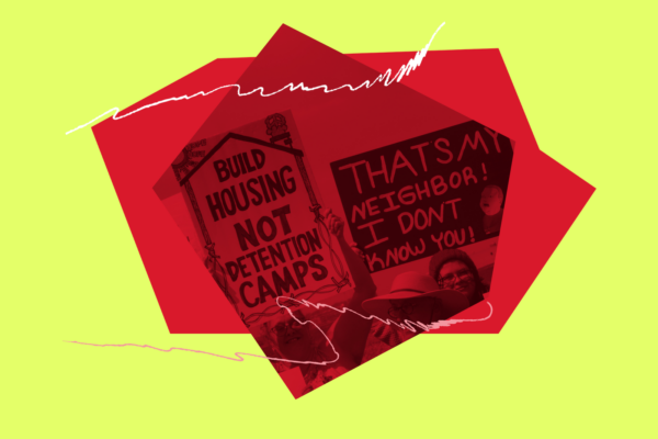 People carry signs at a demonstration.