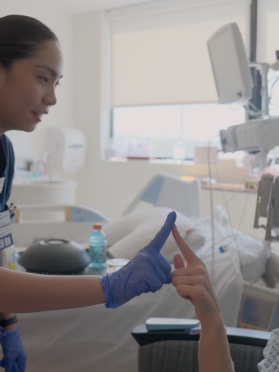 Isabel with a patient at her new job in the neuro ICU in New Jersey.