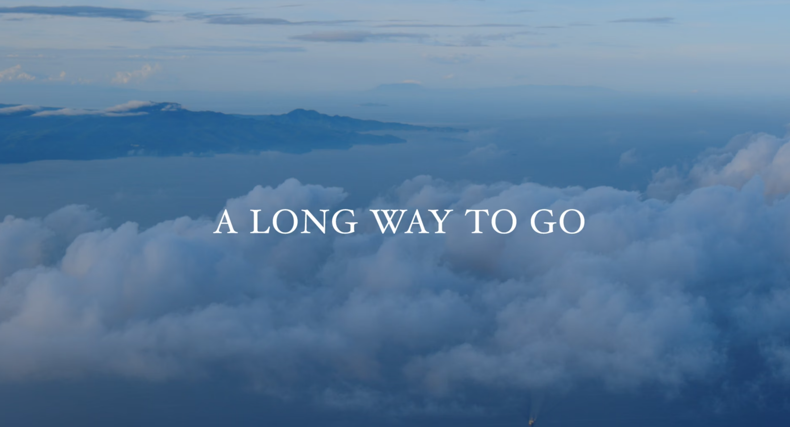 Cover photo showing clouds and the text A Long Way To Go