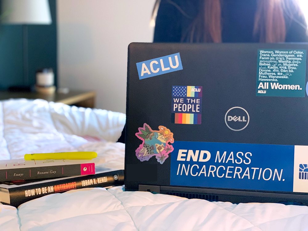 Person working on laptop with ACLU stickers